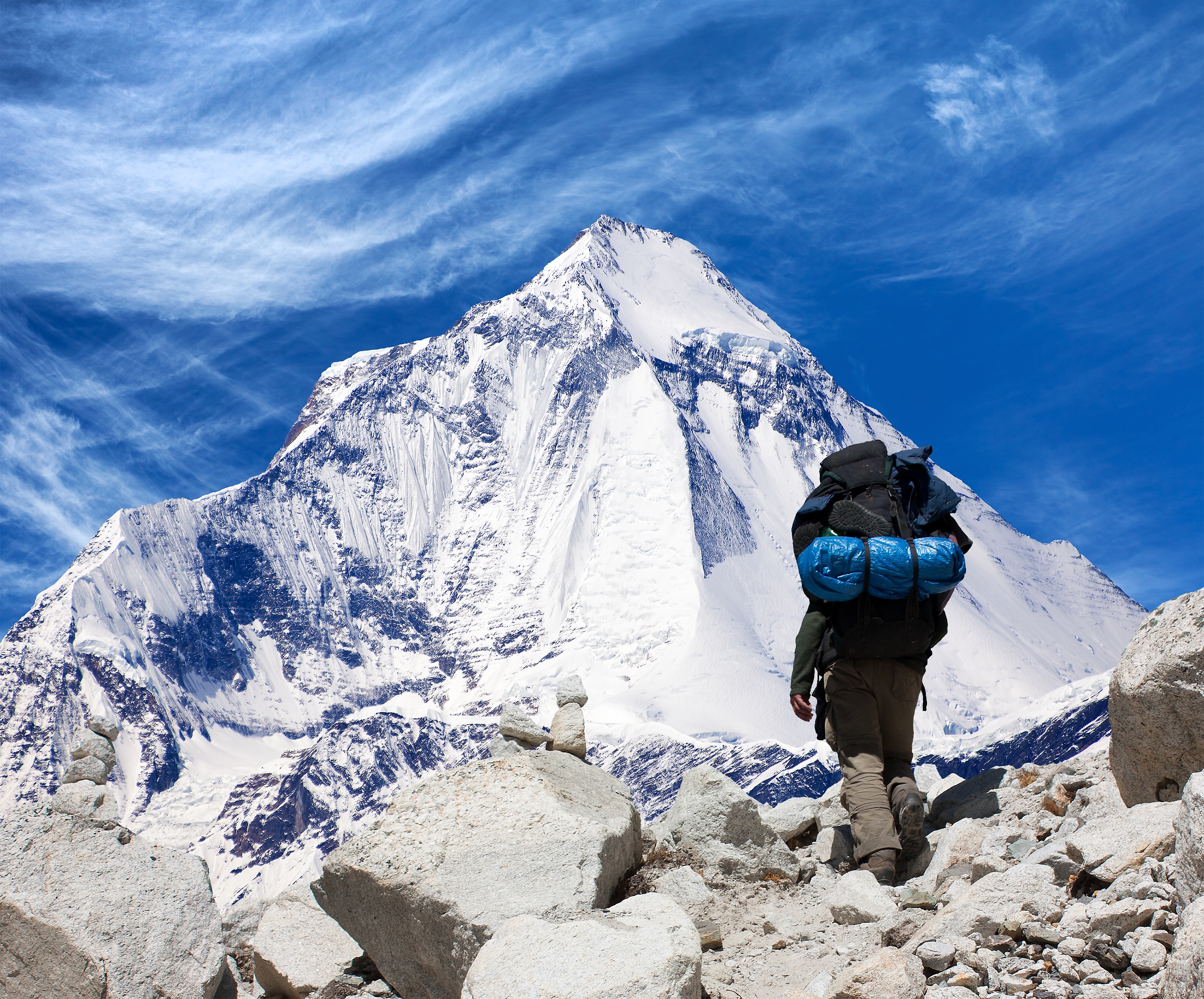 Image of hiker in front of an icy mountain.