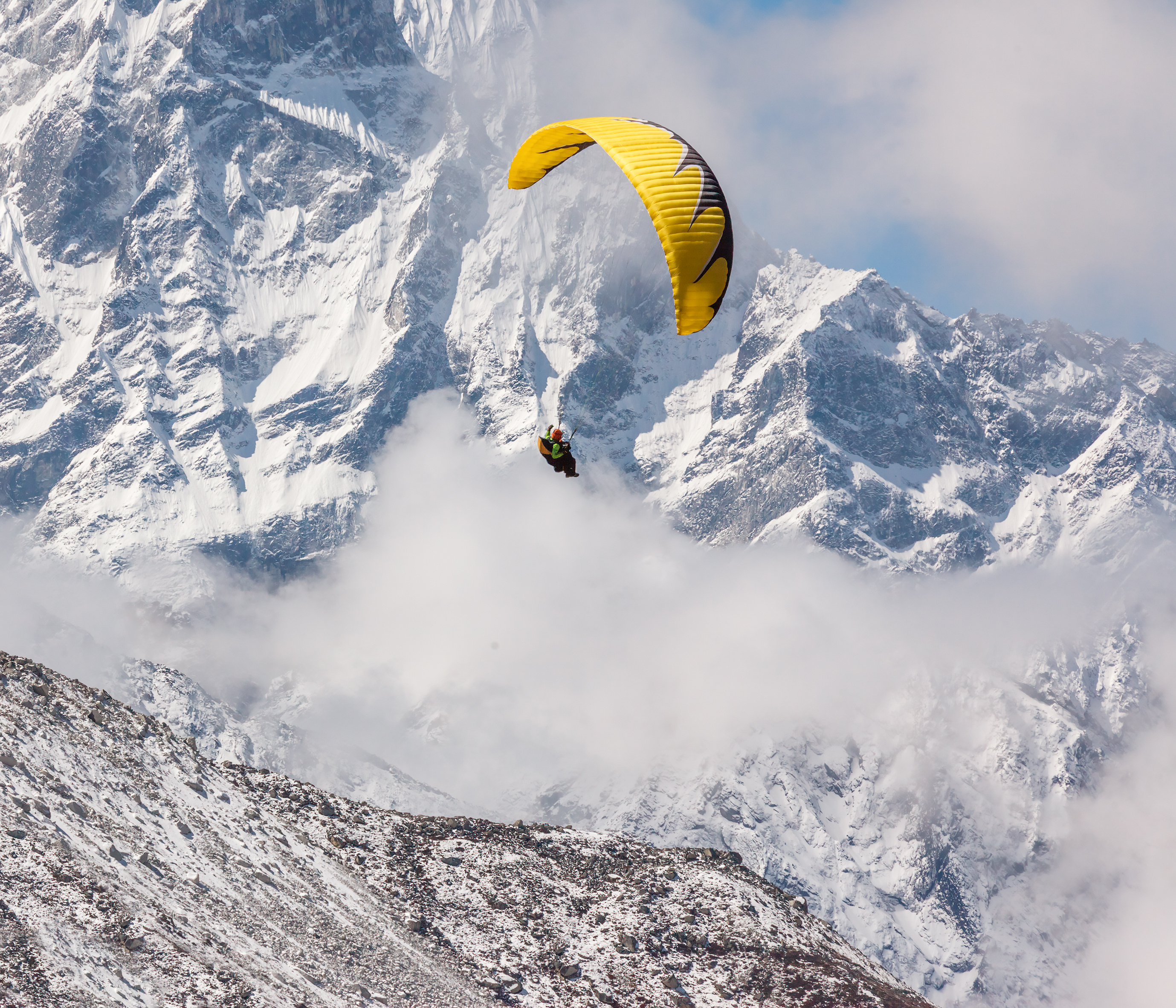 An image of a paraglider in the Himalayas