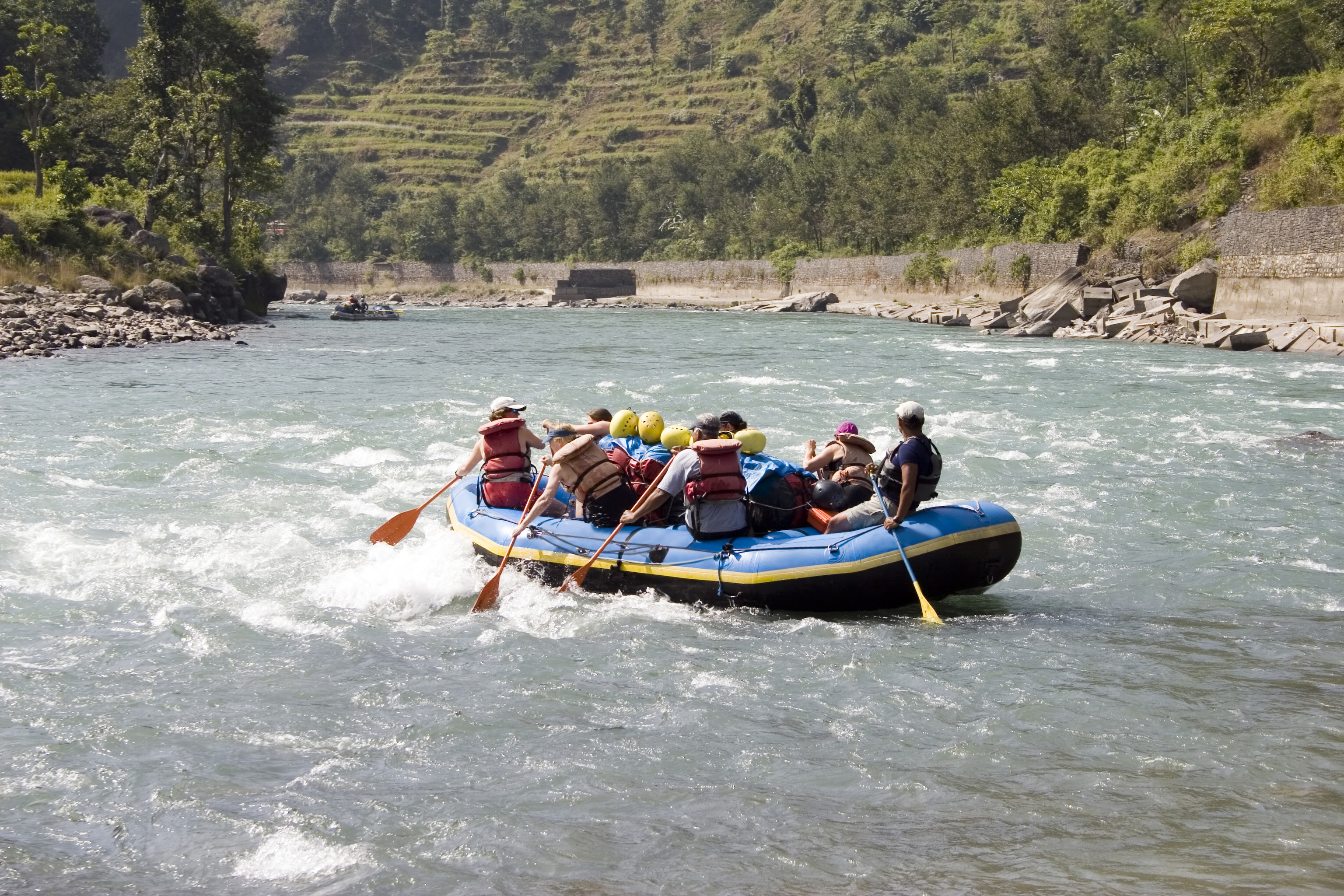 An image of a group of people rafting on a river in Nepal.